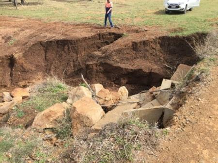 Photo further demonstrating extent and scale of event damage at site